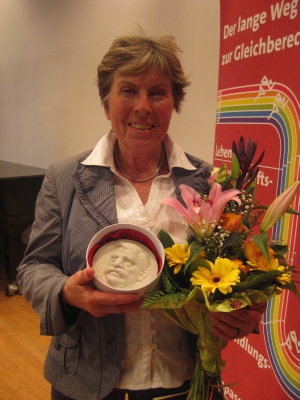 Dagmar Schultz with her Magnus Hirschfeld medal and flowers