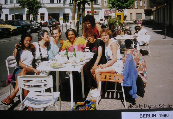 Photo of group of women at an outdoor table on a street in Berlin. Photo © Dagmar Schultz, 1990